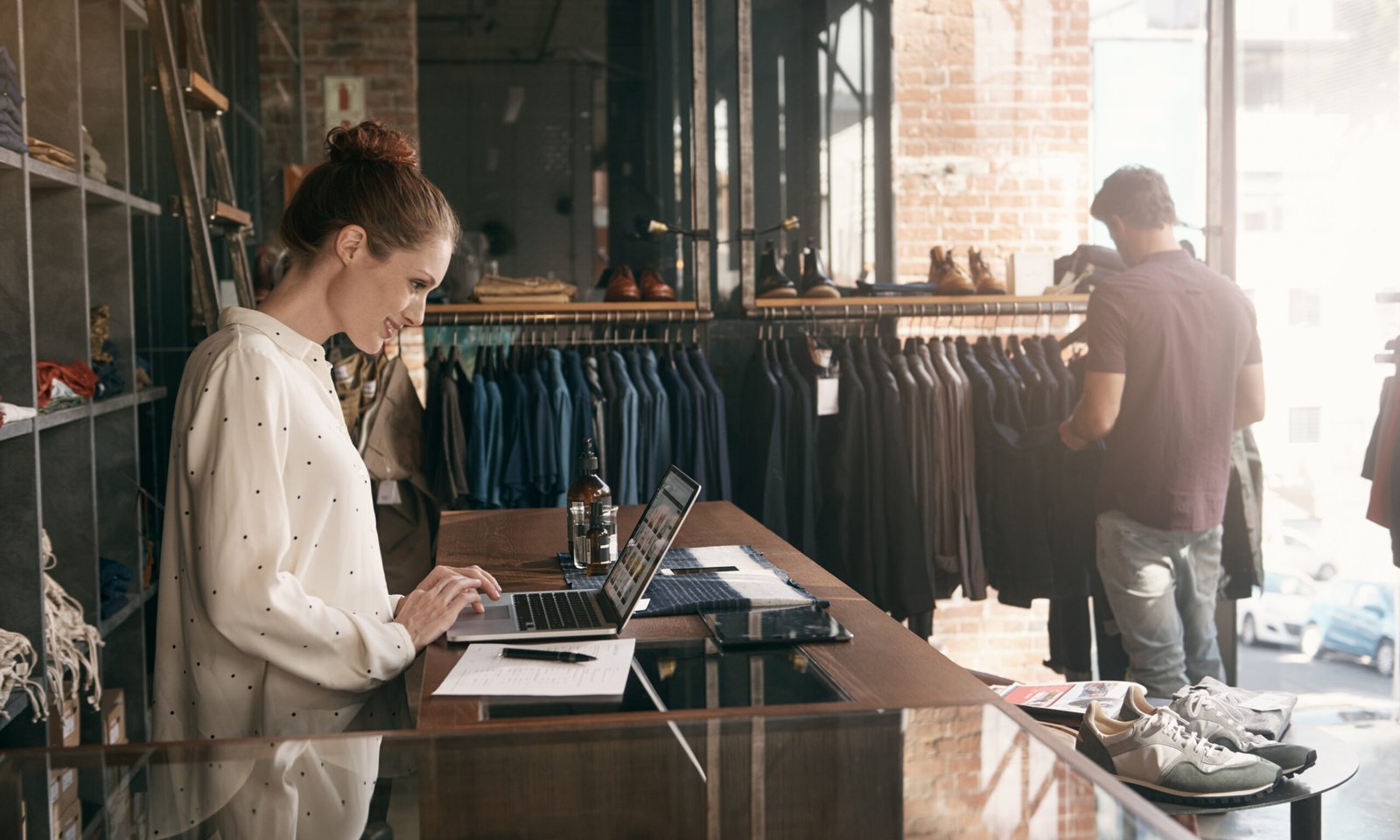 women on her laptop in a clothing store